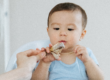 baby eating chicken